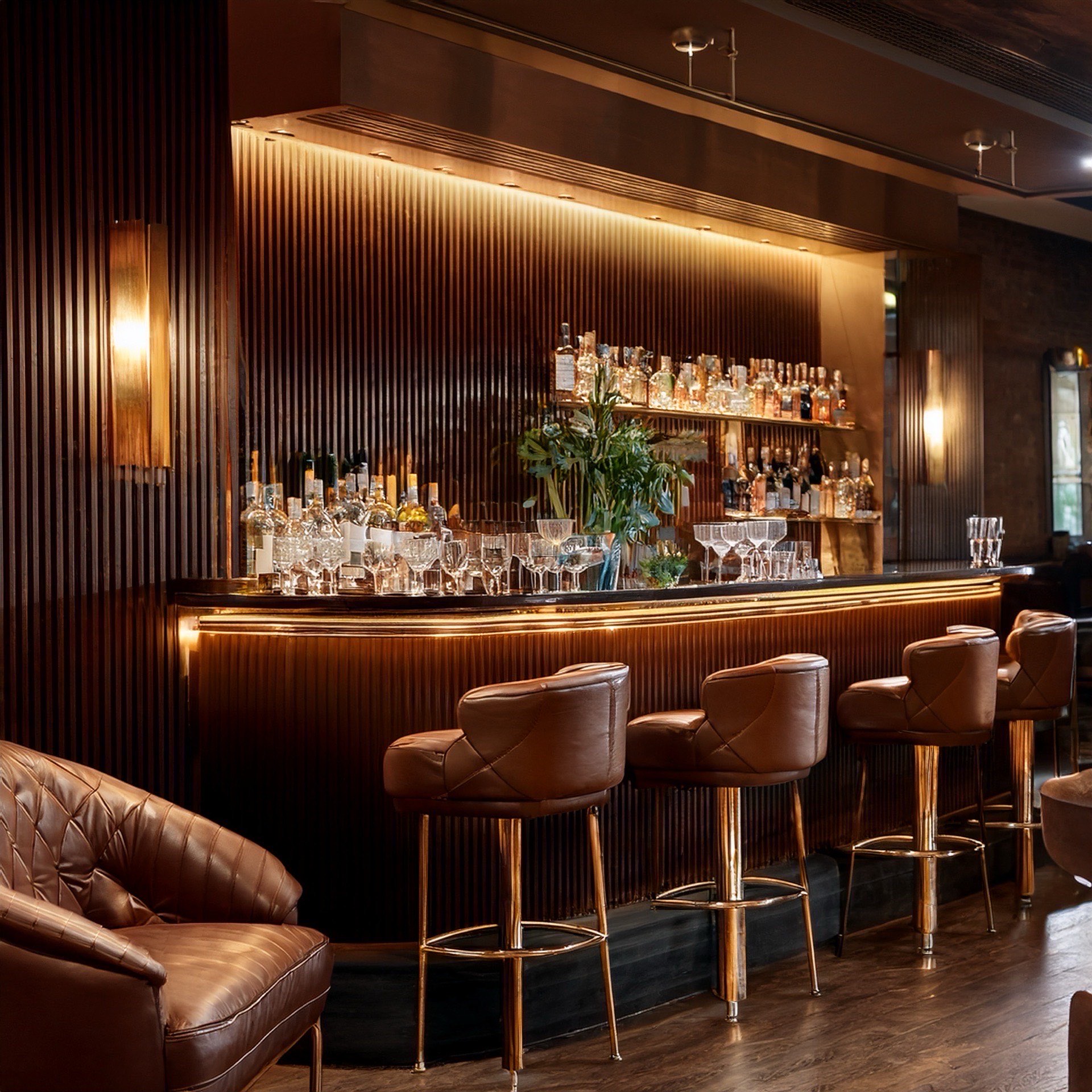 Intimate cocktail lounge with polished wood bar and velvet seating